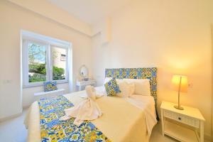 a bedroom with a bed with a bow on it at Apartment Casa Suite Teresa , centro di Forio , Ischia in Ischia