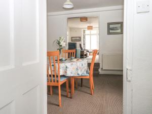 a dining room with a table and chairs and a room with at Clarendon House in Dawlish