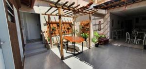 a balcony with a wooden table and a chair at Pousada Azevedo in Livramento de Nossa Senhora