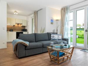 a living room with a couch and a table at Windwatt in Gollwitz