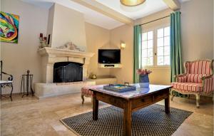 a living room with a fireplace and a table at Gorgeous Home In Montaren Et St Mediers in Labaume