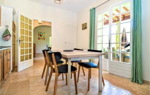 a kitchen and dining room with a table and chairs at Gorgeous Home In Montaren Et St Mediers in Labaume