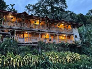 a house on top of a hill with lights at Camiguin Blue Lagoon Cottages in Mahinog