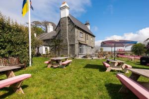 a group of picnic tables in front of a building at St Anne's House in Plymouth