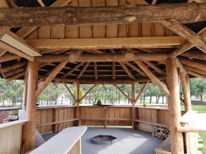 a large wooden pavilion with a fire pit in it at Ośrodek Wypoczynkowy EDEN Maniowy in Maniowy