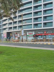 a large building with a street in front of it at full sea view 2 bhk apartment in Ajman 