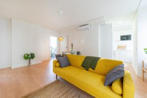 sala de estar con sofá amarillo en una habitación en Monsanto Hill House - NO 571 1E, en Lisboa