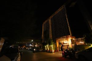 een gebouw met kerstverlichting 's nachts bij Hotel Palm Grand Naraina New Delhi - Couple Friendly Local IDs Accepted in New Delhi