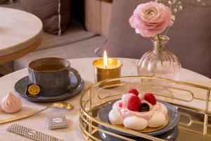 a table with a plate of food and a candle at Hôtel Beige in Paris +80 photos
