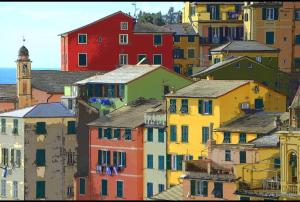 a group of colorful houses in a city at A due passi dal mare in Sori