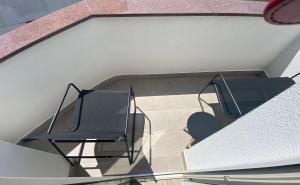 a balcony with two chairs on a building at Villa Mara in Pula