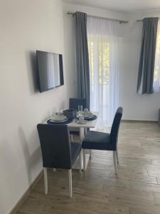 a dining room with a table and chairs and a television at Villa Mara in Pula