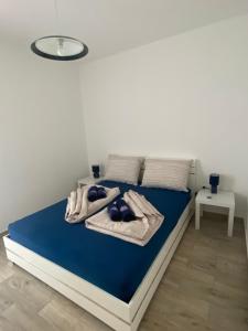 a bedroom with a blue bed with towels on it at Villa Mara in Pula