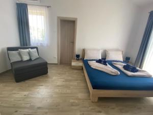 a bedroom with a blue bed and a chair at Villa Mara in Pula