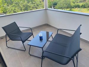 two chairs and a table on a balcony at Villa Mara in Pula