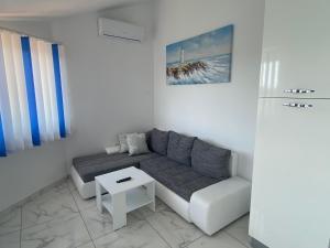 a white living room with a couch and a table at Villa Mara in Pula