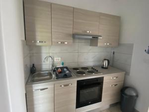 a small kitchen with a sink and a stove at Villa Mara in Pula