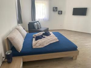 a bedroom with a bed with blue sheets and a chair at Villa Mara in Pula