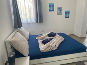 a bedroom with a bed with a blue mattress at Villa Mara in Pula