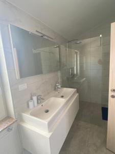 a white bathroom with a sink and a mirror at Villa Mara in Pula