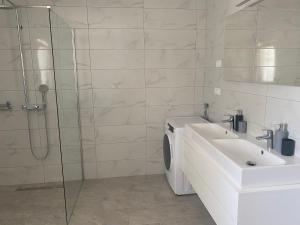 a bathroom with a washing machine and a sink at Villa Mara in Pula