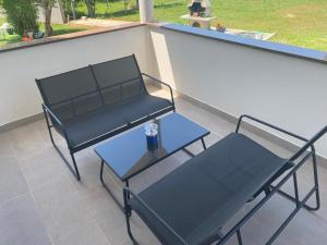 two chairs and a table on a balcony at Villa Mara in Pula