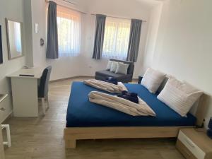 a bedroom with a blue bed and a desk at Villa Mara in Pula