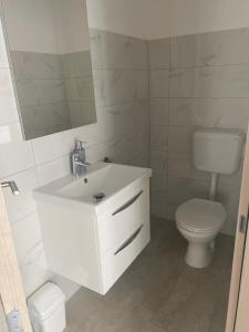 a bathroom with a white sink and a toilet at Villa Mara in Pula