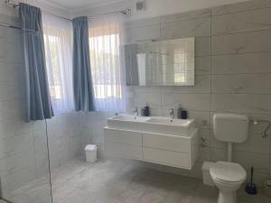 a white bathroom with a sink and a toilet at Villa Mara in Pula +37 photos