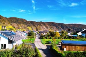 a small town with a mountain in the background at Ferienweingut Gansen / Hochgenuss 1 in Ernst