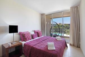 a bedroom with a large bed and a large window at Apartamento Herdade dos Salgados in Guia +23 photos