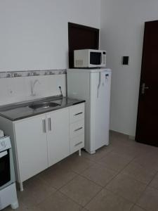 a small kitchen with a sink and a microwave at RCM Vilas - STUDIO n 06 in Joinville