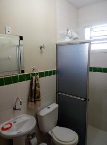 a small bathroom with a toilet and a sink at RCM Vilas - STUDIO n 06 in Joinville