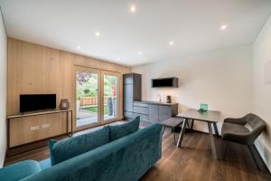 a living room with a couch and a table at Naturapartments Alpreid Tanne in San Pancrazio dʼUltimo