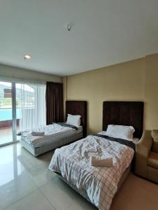 En eller flere senger på et rom på Spacious & Homey Apartment at Marina Island by JoMy Homestay