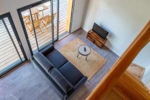 a living room with a couch and a table at Les Cottages de Ripaille in Thonon-les-Bains +5 photos