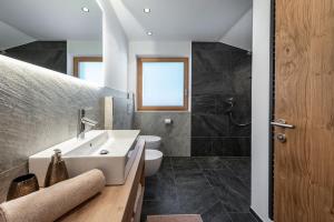 a bathroom with a sink and a toilet at Mesnerhof in Valles