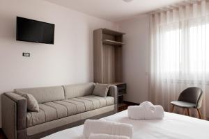 a living room with a couch and a tv at B&B Monna Lisa Rooms in Montesano Scalo