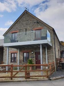 a brick house with a wooden fence in front of it at The Hay Suite in Aberystwyth