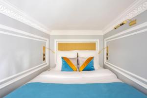 a bedroom with a bed with blue and orange pillows at Luxury 3 bedrooms 2 Bathrooms - Ile saint-Louis in Paris