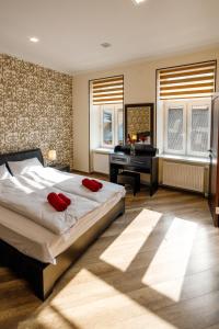 a bedroom with a bed and a desk and a piano at Apartments Rynok Square 12 in Lviv