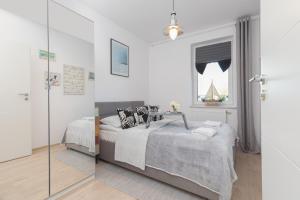 Posteľ alebo postele v izbe v ubytovaní Osiedle Feniks Kołobrzeg by Noclegi Renters + 37 fotografií