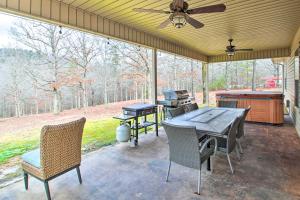 a screened porch with a table and chairs and a grill at Grand Hot Springs Home Less Than 5 Mi to Lake Desoto! in Hot Springs Village