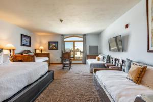 a hotel room with two beds and a couch at The Caledonian in Park City