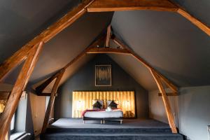 a room with a bed in the attic at Domaine Malar in Guillerval +50 photos
