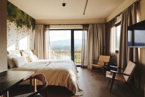 a bedroom with a bed and a large window at Boutiquehotel DAS ZEITWERT in Deutschlandsberg +103 photos