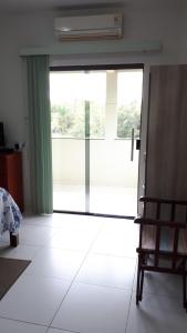 a room with a large window and a white floor at Pousada Recanto do Japa in Nilo Peçanha