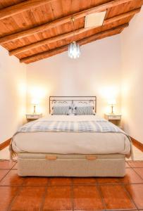 a bedroom with a large bed with two night stands at CASA DA ALDEIA II in Alcaria Ruiva