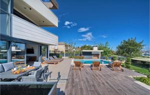 a patio with chairs and a table and a pool at Nice Home In Kastel Gomilica With Sauna in Kaštela