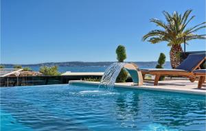 a swimming pool with a fountain in the middle at Nice Home In Kastel Gomilica With Sauna in Kaštela +41 photos